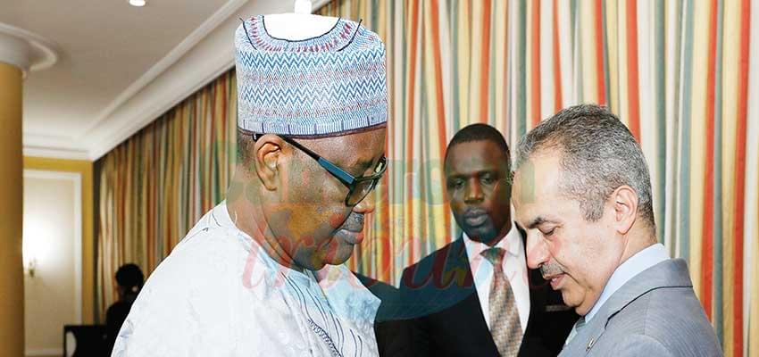 Minister Adoum Gargoum affixing the medal of Grand Officer of the National Order of Valour on Mohammed Suliman Almussher.