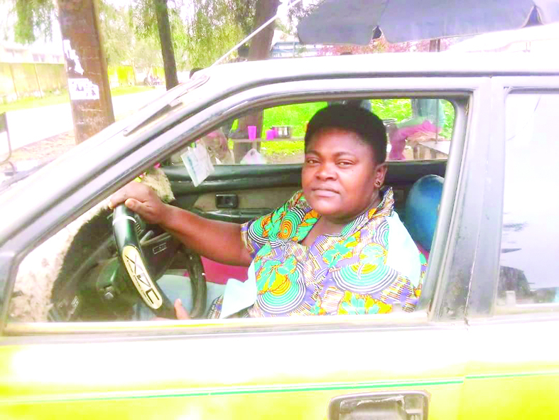 Sophie Njie Ewokolo in her cab in Buea. Sophie Njie Ewokolo in her cab in Buea.