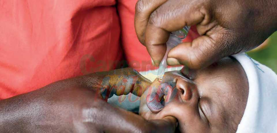 A drop of the inoculation being administered to a child.