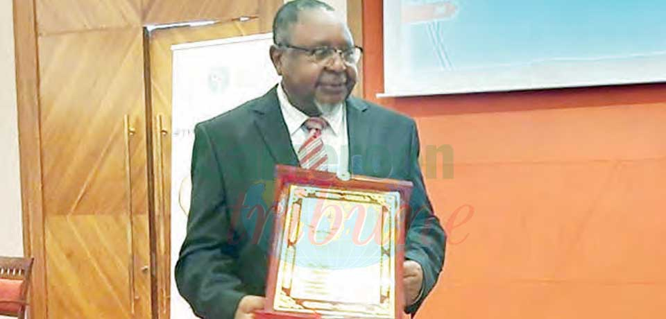 Professor Beban Chumbow brandishes his award.