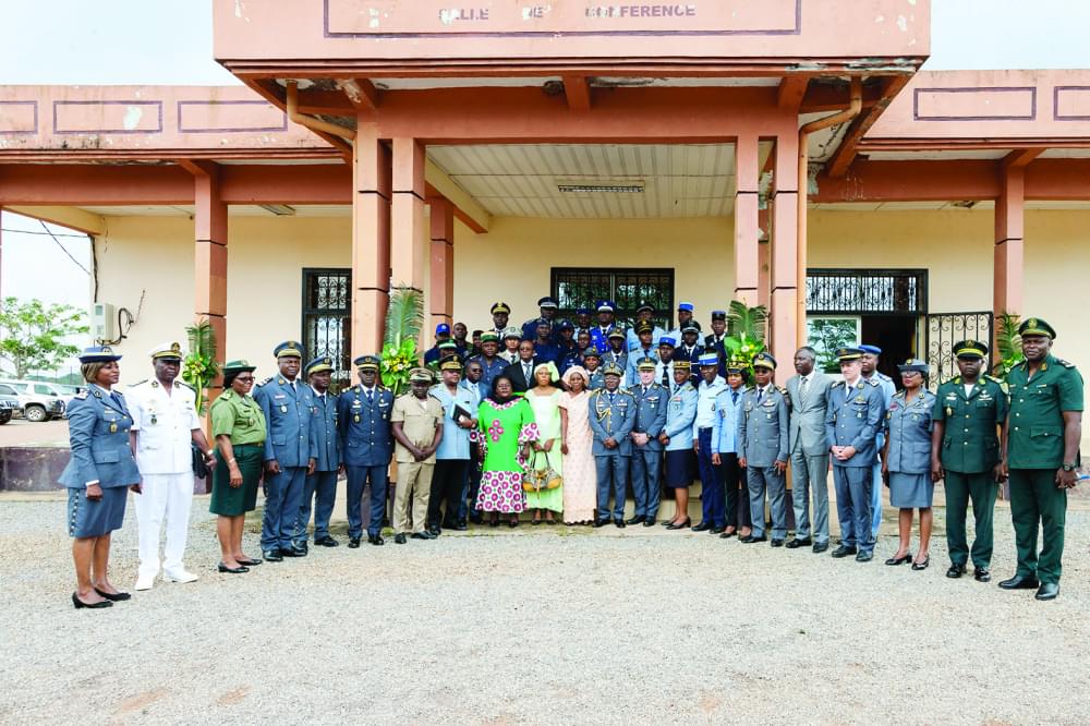 Trained officers ready to serve their countries pose with authorities.