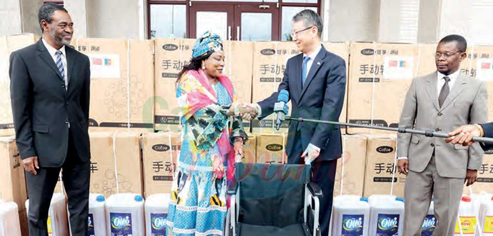 Ambassador Wang Yingwu and Habissou Bidoung in a symbolic handover of the donation.