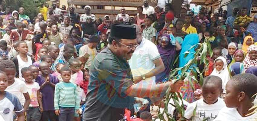 Minister Mbayu with peace plant in hand as he communes with the population